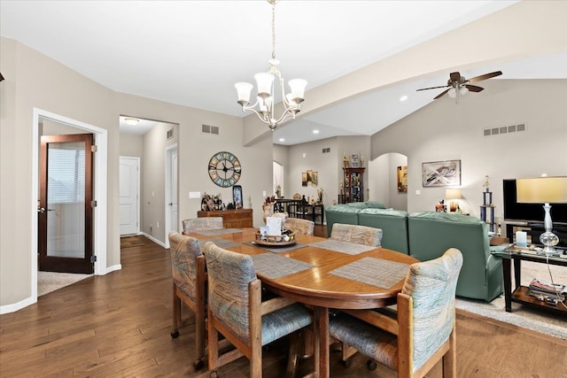 dining area featuring vaulted ceiling, ceiling fan with notable chandelier, and dark hardwood / wood-style floors