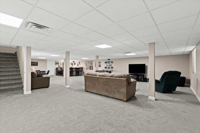 carpeted living room with a paneled ceiling