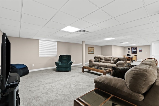 carpeted living room with a drop ceiling