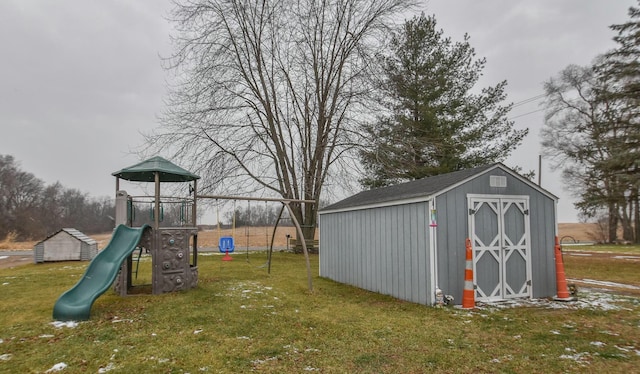 view of play area featuring a yard and a storage unit