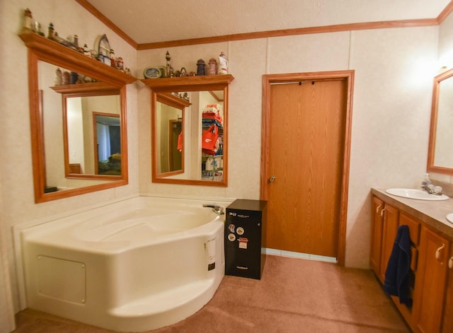 bathroom with vanity, a textured ceiling, a tub to relax in, and crown molding