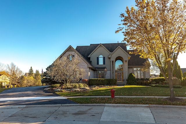 front facade with a front yard