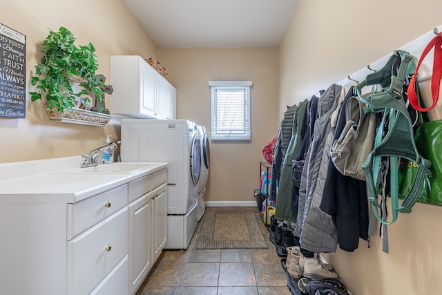 laundry area featuring cabinets, independent washer and dryer, tile patterned floors, and sink