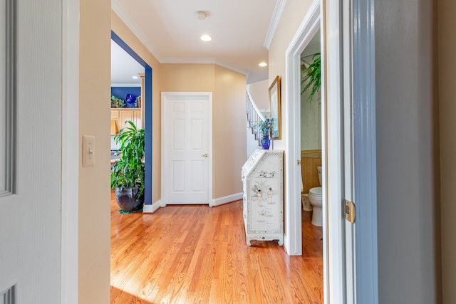 hall featuring light hardwood / wood-style floors and crown molding