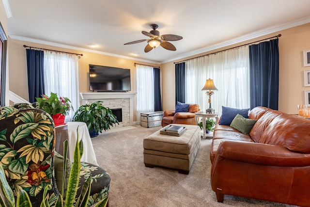 living room featuring a fireplace, carpet, ceiling fan, and crown molding