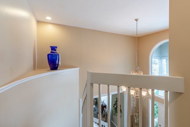 hall featuring a notable chandelier and a wealth of natural light