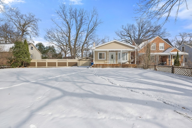 view of front of house featuring a porch, an outdoor structure, and a garage