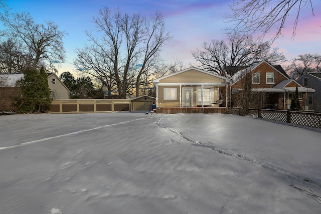 view of front of home featuring covered porch, an outbuilding, and a garage