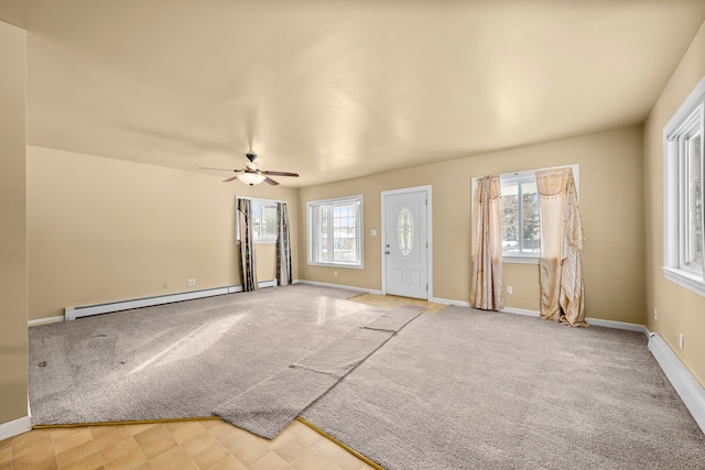 unfurnished room with light colored carpet, ceiling fan, and a baseboard heating unit