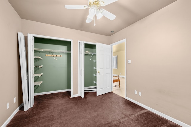 unfurnished bedroom with ceiling fan and dark carpet