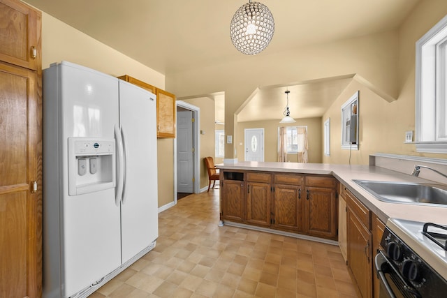 kitchen with white fridge with ice dispenser, sink, black electric range, kitchen peninsula, and decorative light fixtures