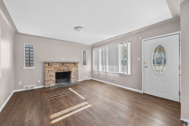 unfurnished living room with dark hardwood / wood-style flooring and a fireplace