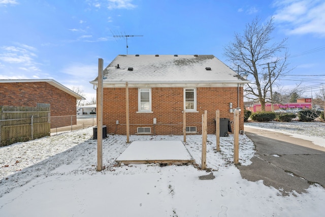 snow covered property featuring central air condition unit