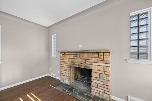 room details featuring a fireplace and wood-type flooring