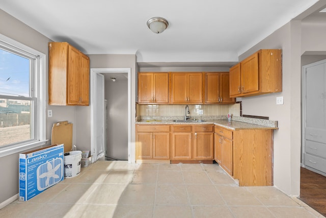 kitchen with sink and light tile patterned flooring