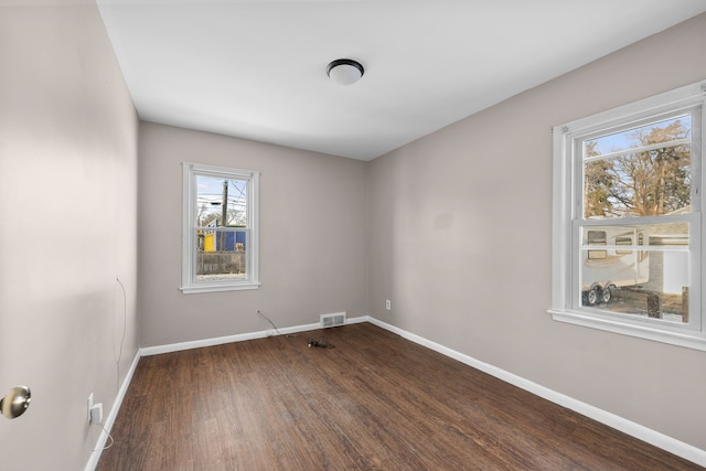 empty room featuring dark hardwood / wood-style flooring