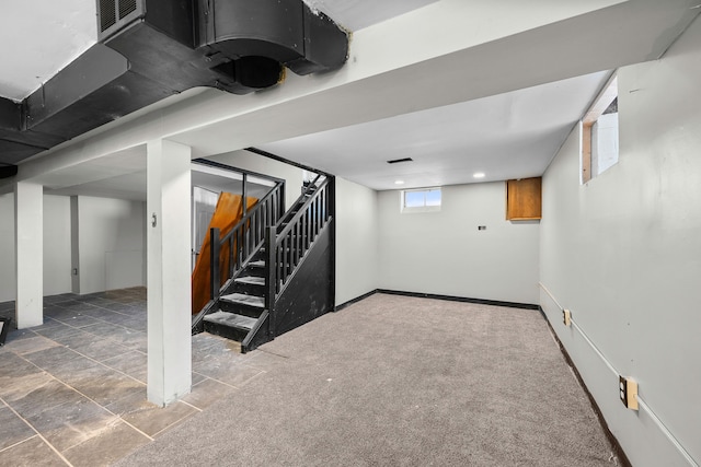 basement featuring dark carpet