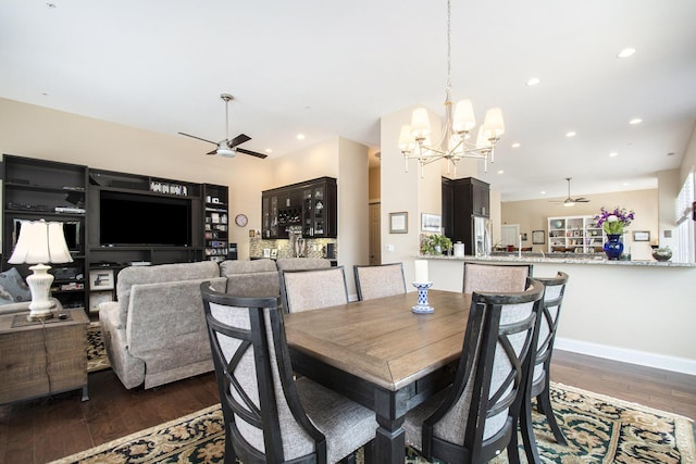 dining space with dark wood-type flooring and ceiling fan with notable chandelier