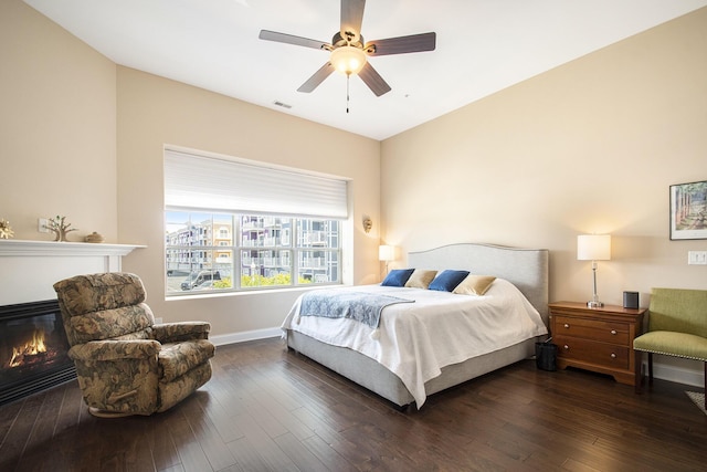 bedroom with ceiling fan and dark hardwood / wood-style flooring