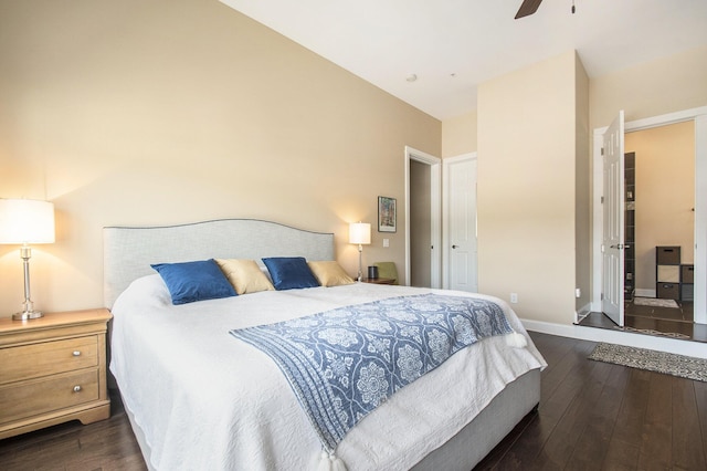 bedroom featuring ceiling fan, dark hardwood / wood-style flooring, and vaulted ceiling