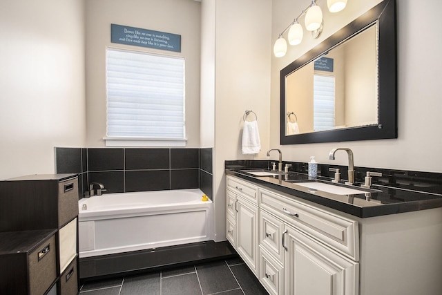 bathroom featuring vanity, a tub to relax in, and tile patterned floors