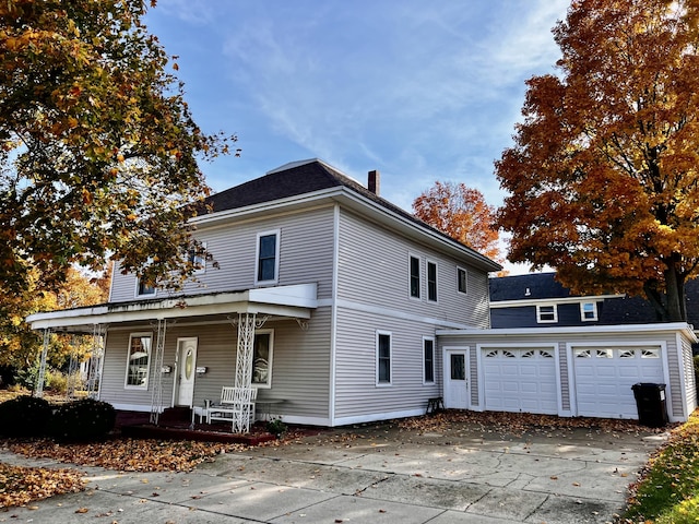 view of front property featuring a garage and covered porch