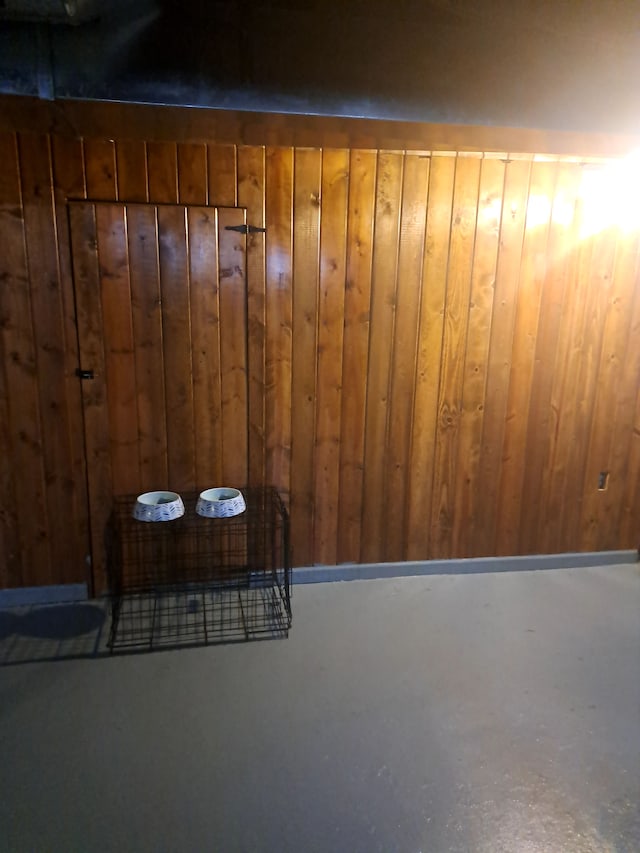 interior details featuring wood walls and concrete floors