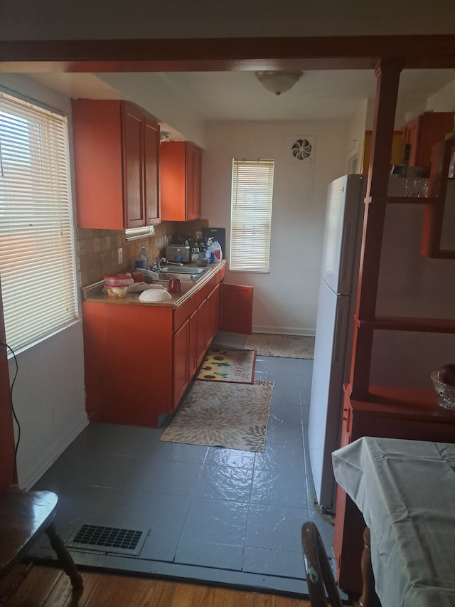 kitchen featuring backsplash, dark wood-type flooring, sink, billiards, and white fridge