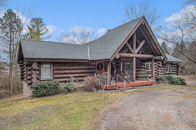 log-style house with covered porch