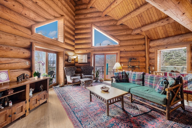 living room with log walls, light wood-type flooring, high vaulted ceiling, and wooden ceiling