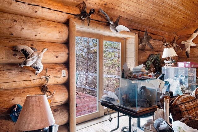 interior space featuring log walls, wood ceiling, and hardwood / wood-style flooring