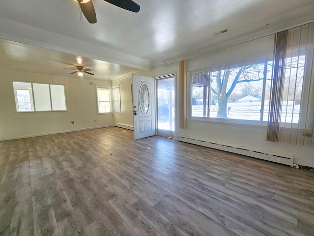 entrance foyer with ceiling fan, wood-type flooring, and a baseboard heating unit