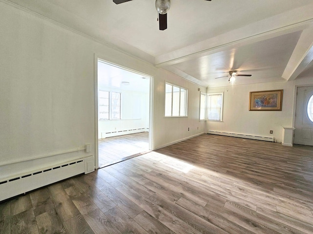 unfurnished living room with hardwood / wood-style flooring, beam ceiling, and a baseboard radiator