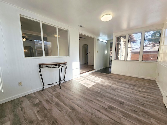 empty room with dark hardwood / wood-style flooring and ceiling fan