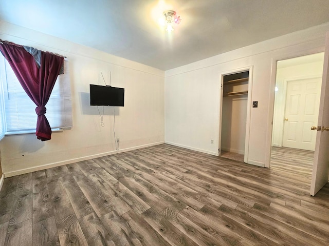 unfurnished bedroom featuring a closet and wood-type flooring