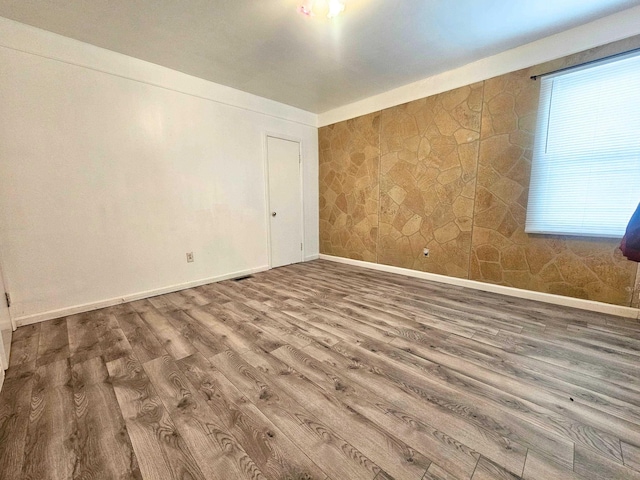 unfurnished room with hardwood / wood-style floors