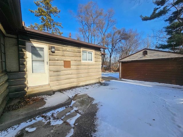 exterior space featuring a garage and an outdoor structure