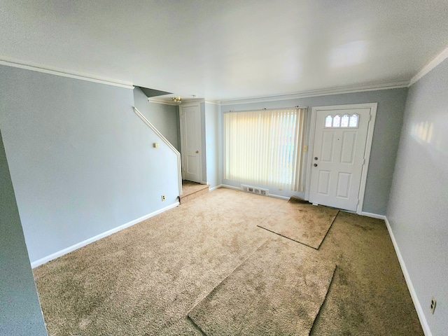 carpeted entrance foyer with ornamental molding