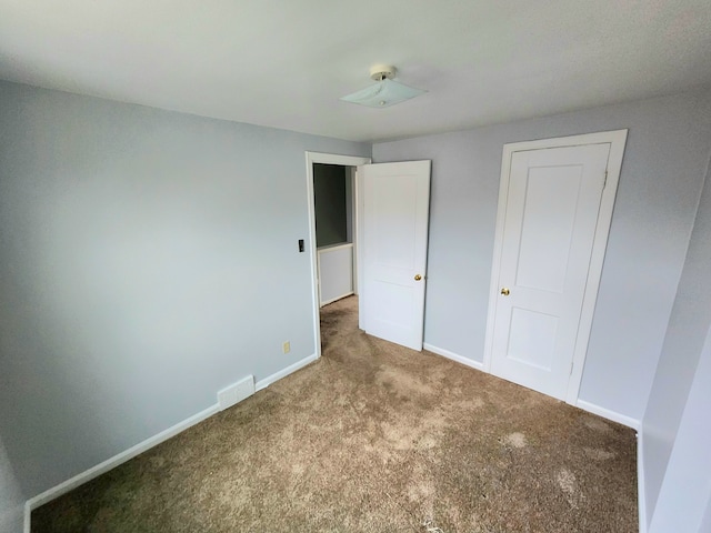 unfurnished bedroom with carpet floors