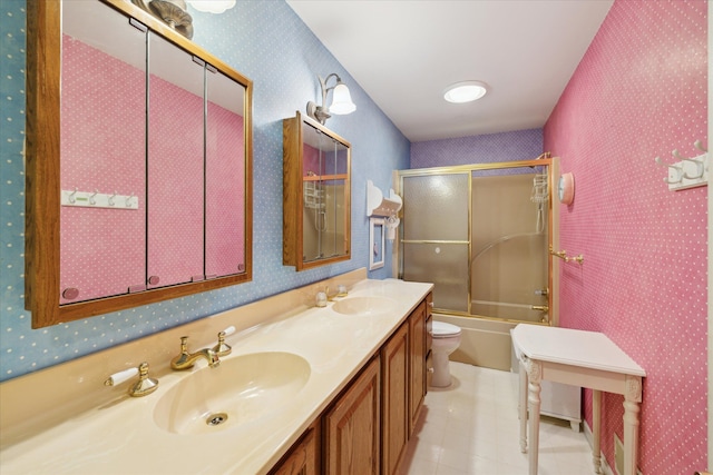 full bathroom featuring vanity, shower / bath combination with glass door, and toilet