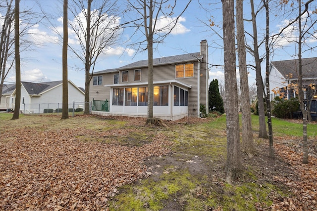 back of house featuring a sunroom