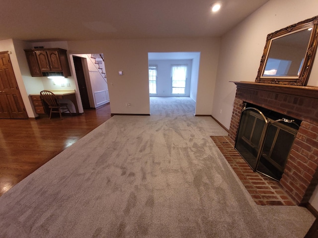 carpeted living room with a fireplace