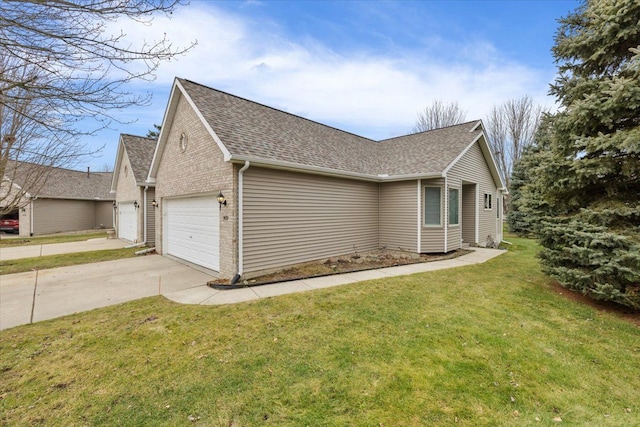 view of side of home with a lawn and a garage