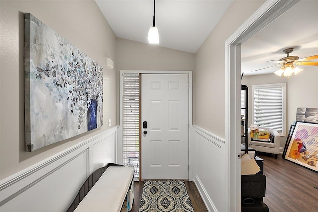 foyer with dark hardwood / wood-style floors, ceiling fan, and vaulted ceiling