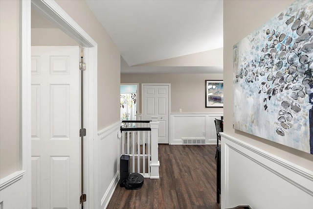 corridor featuring dark hardwood / wood-style floors and lofted ceiling