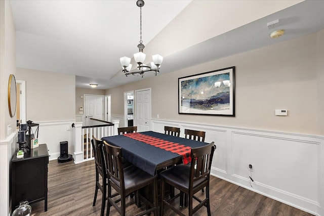 dining area featuring vaulted ceiling, dark hardwood / wood-style floors, and a notable chandelier