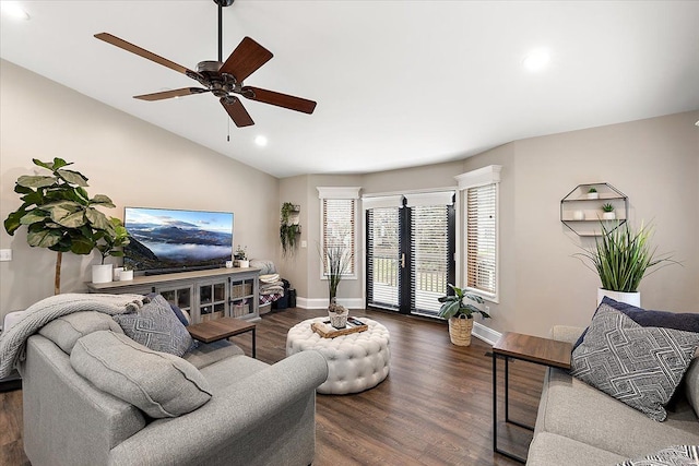 living room with vaulted ceiling, ceiling fan, and dark wood-type flooring