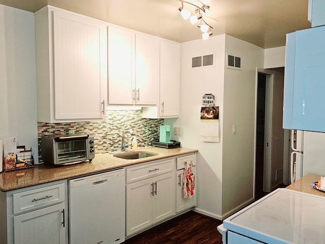 kitchen with dishwasher, white cabinets, stove, and sink