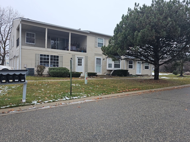 view of front of home with a front yard and a garage