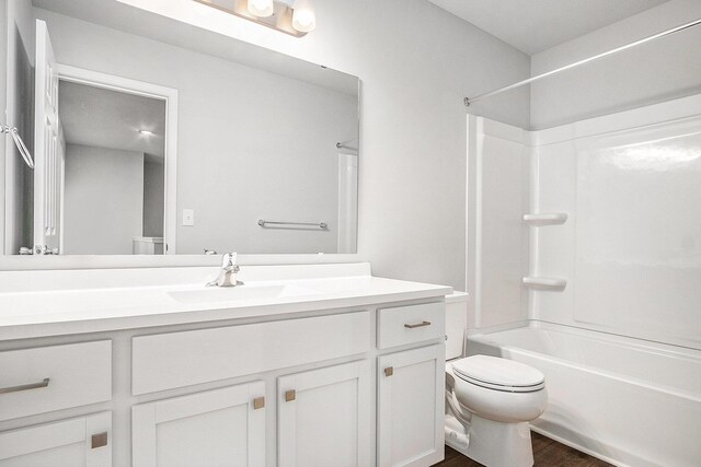 7942 Sierra Dr, Belding, MI 48809 - bathroom with wood finished floors, vanity, toilet, and bathing tub / shower combination